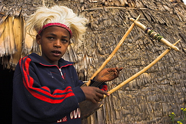 Dorze boy with musical instrument made from bamboo, Chencha mountains, Ethiopia, Africa