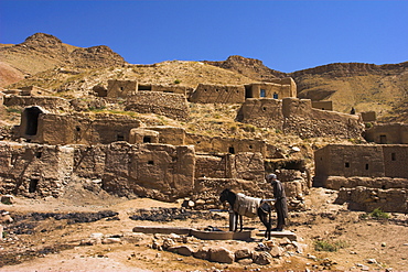 Man and donkey at well, between Herat and Maimana, after Subzak pass, Afghanistan, Asia