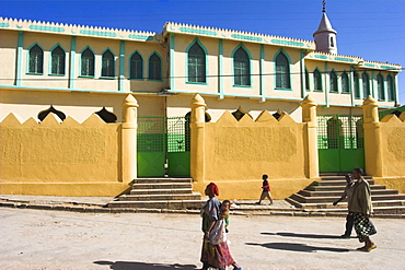 People walking past Jamia Mosque, built in the 16th century, Old Town, Harar, Ethiopia, Africa