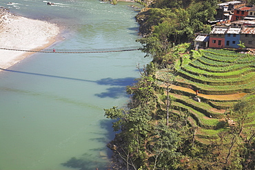 Suspension bridge and terraced fields in front of the Trisuli Center, whitewater base for Himalayan Encounters, Bandare village, Trisuli Valley, Nepal, Asia