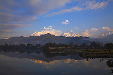 Annapurna range reflecting in Fewa (Phewa) Lake at dawn, Pokhara, Nepal, Asia