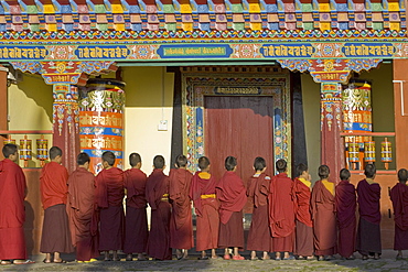 Novice monks line up in front of monastic building at the new Karma Theckhling Monastery, built in traditional Sikkim style, Ravangla (Rabongla), Sikkim, India, Asia