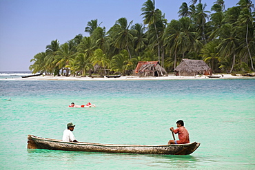 Men in dugout canoe near Devil Island, Comarca de Kuna Yala, San Blas Islands, Panama, Central America