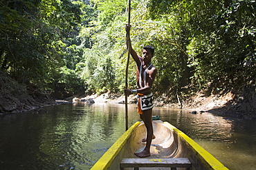 Embera Indian man in dugout canoe on Chagres River, Panama, Central America