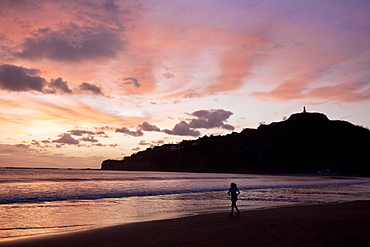 Woman walking along beach, San Juan Del Sur, Nicaragua, Central America