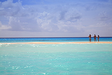 Tourists chatting on sandbank, Cayo De Agua, Archipelago Los Roques National Park, Venezuela, South America