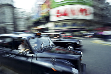 Taxis in Piccadilly Circus, London, England, United Kingdom, Europe