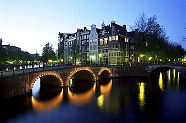 Canals, illuminated bridges and traditional buildings at night, Amsterdam, Holland, Europe