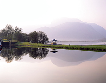 Ben Nevis reflected in the Caledonian Canal, early morning, Corpach, near Fort William, Western Highlands, Scotland, United Kingdom, Europe