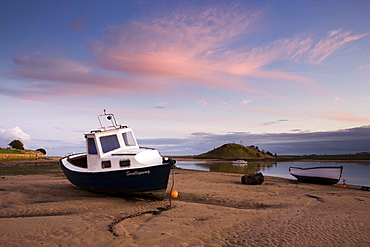 Fishing boat on the Aln Estuary at twilight, low tide, Alnmouth, near Alnwick, Northumberland, England, United Kingdom, Europe