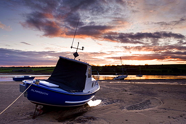 Fishing boat on the Aln Estuary at sunset, Alnmouth, near Alnwick, Northumberland, England, United Kingdom, Europe