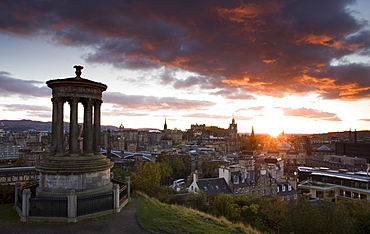 View over Edinburgh from Calton Hill at sunset with the Dugald Stewart Monument in the foreground, Edinburgh, Lothian, Scotland, United Kingdom, Europe