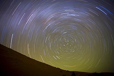 Star trails captured using an exposure time of two hours to record the rotation of the earth on its Polar Axis, stars are rotating around the Pole Star (Polaris), the Sahara Desert near Merzouga, Morocco, North Africa, Africa