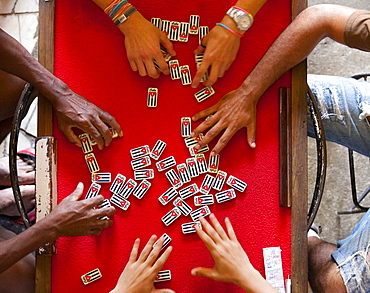 Overhead view of people playing with dominos marked with country name and the Cuban flag, Havana, Cuba, West Indies, Central America