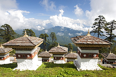 Some of the 108 Chortens located at the summit of the Dochu La Pass with views towards distant forested mountains between Thimpu and Punakha, Bhutan, Himalayas, Asia