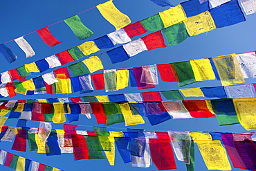 Colourful prayer flags against clear blue sky at Bodhnath Stupa (Boudhanth) (Boudha), one of the holiest Buddhist sites in Kathmandu, Kathmandu, Nepal, Asia