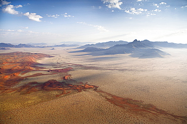 Aerial view from hot air balloon over magnificent desert landscape of sand dunes, mountains and Fairy Circles, Namib Rand game reserve Namib Naukluft Park, Namibia, Africa