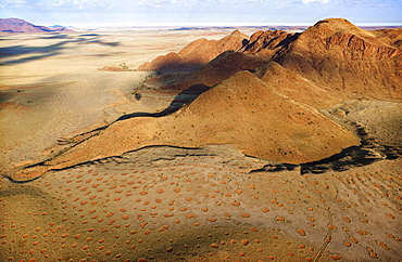 Aerial view from hot air balloon over magnificent desert landscape of sand dunes, mountains and Fairy Circles, Namib Rand game reserve Namib Naukluft Park, Namibia, Africa