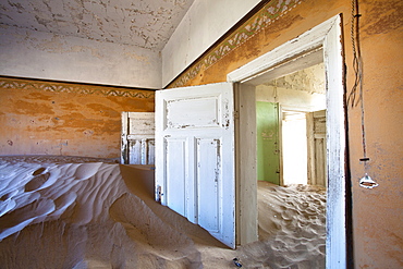 Interior of building slowly being consumed by the sands of the Namib Desert in the abandoned former German diamond mining town of Kolmanskop, Forbidden Diamond Area near Luderitz, Namibia, Africa