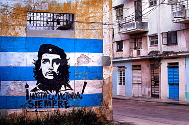 Mural of Che Guevara and the Cuba, West Indies, Central American flag painted on a wall, Havana, Cuba, West Indies, Central America