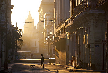 Backlit street at dawn with people in semi-silhouette, off Prado, Havana Centro, Havana, Cuba, West Indies, Central America 