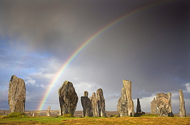 Standing Stones of Callanish bathed in sunlight with a rainbow arching across the sky in the background, near Carloway, Isle of Lewis, Outer Hebrides, Scotland, United Kingdom, Europe