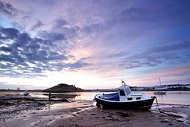 Winter sunrise on the Aln Estuary looking towards Church Hill with boats moored and reflections in the calm water, Alnmouth, near Alnwick, Northumberland, England, United Kingdom, Europe 