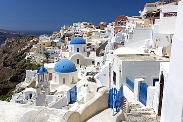 Classic view of the village of Oia with its blue domed churches and colourful houses, Oia, Santorini, Cyclades, Greek Islands, Greece, Europe