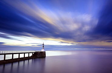 Long exposure image of Amble Lighthouse with streaky clouds and smooth sea, Amble, Northumberland, England, United Kingdom, Europe