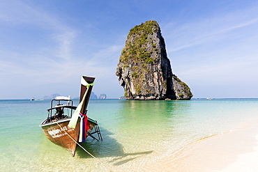 Traditional Longtail boat moored by Phra Nanag Beach with limestone islands in the background, Krabi, Thailand, Southeast Asia, Asia