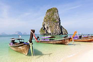 Traditional Longtail boats moored by Phra Nanag Beach with limestone islands in the background, Krabi, Thailand, Southeast Asia, Asia