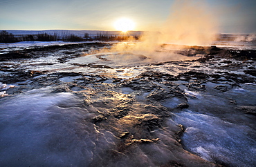 Hot pools and steam from Strokkur Geysir at sunrise, winter, at geothermal area beside the Hvita River, Geysir, Iceland, Polar Regions