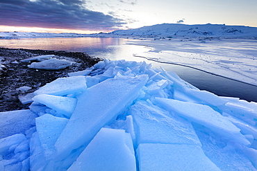 Sunset over frozen Jokulsarlon Glacial Lagoon in winter, South Iceland, Polar Regions