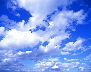 Cloudscape of puffy white clouds in a blue sky