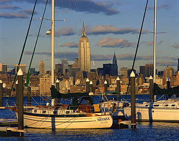 Boats in the harbour with the Empire State Building on the skyline in the background, in New York, United States of America, North America