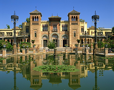 Reflections in the lily pond of buildings on the Plaza de Espana in the city of Seville, Andalucia, Spain, Europe