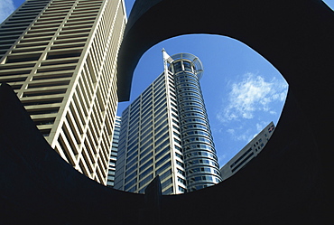 Skyscrapers of the Raffles Business Centre from a low angle seen through the frame of sculpture, Singapore, Southeast Asia, Asia