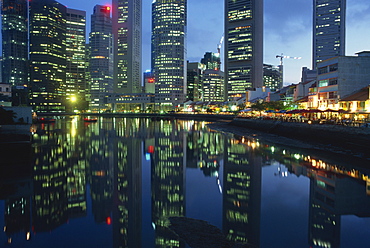 Reflections of the lights of buildings on Boat Quay and Raffles Place at night in Singapore, Southeast Asia, Asia