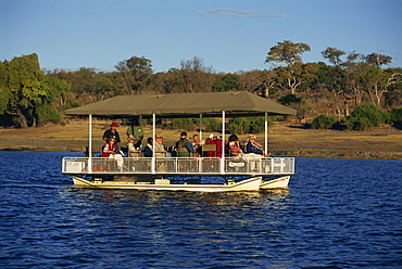 Tourists game viewing on boat on the Chobe River, Chobe National Park, Botswana, Africa