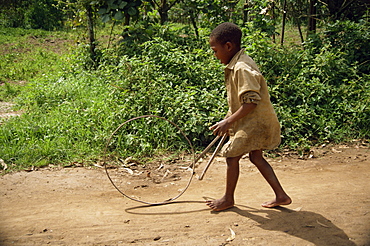 Boy playing with hoop, Kabale, Uganda, Africa