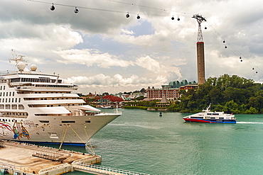 Cruise ship moored at Harbourfront Centre, Singapore, with Sentosa Island resort behind and Sky Network cable car overhead, Singapore, Southeast Asia, Asia