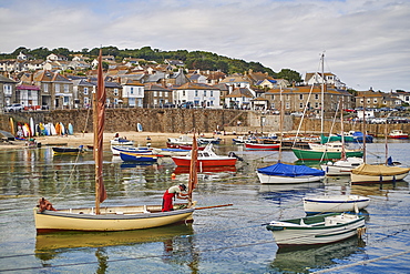 A fisherman makes ready his oyster dredger before setting out from Mousehole Harbour, Penwith, Cornwall, England, United Kingdom, Europe