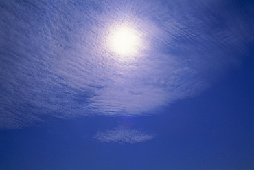 Altocumulus clouds in front of the sun, high above Tadley, near Basingstoke, Hampshire, England, United Kingdom, Europe