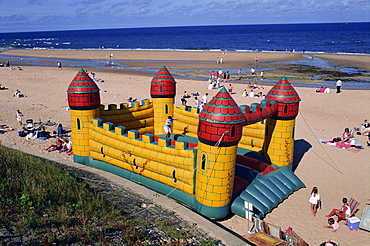 Bouncy castle on the beach at Whitley Bay, Tyneside, England, United Kingdom, Europe