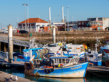 Port area of Le Havre showing fishing boats and iconic twin chimneys, Le Havre, Normandy, France, Europe