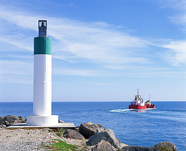 Boat in the Tasman Sea outside the harbour entrance at Westport, Westland, South Island, New Zealand, Pacific