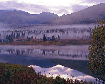 Dawn mist in autumnal colours and hunters cabin closed for the winter, Kenai Peninsula, Alaska, USA, North America