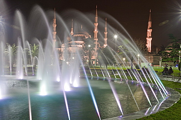 Coloured fountains at night in Sultan Ahmet Park, a favourite gathering place for locals and tourists, looking towards the Blue Mosque, Istanbul, Turkey, Europe