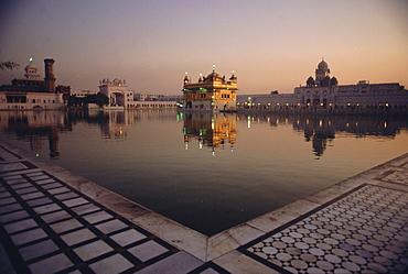 Dawn at the Golden Temple and cloisters and the Holy Pool of Nectar, sacred site of the Sikh religion, Amritsar, Punjab State, India, Asia