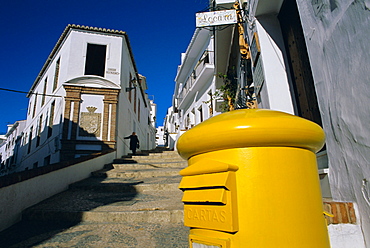 Typical street, yellow post-box and lady in black, Frigiliana, Malaga Province, Andalucia (Andalusia), Spain, Europe